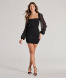 The Meilani Rhinestone Mesh Long Sleeve Mini Dress is a stunning black mini dress with a short hem, designed to be the perfect winter cocktail dress or night-out look for the holiday season.