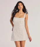 The Clarice Sequin Beaded Lace A-Line Mini Dress is a white dress, an essential holiday or NYE dress that pairs chic style with versatility making it perfect for cocktail events, New Year's Eve parties, or as a winter wedding guest look.