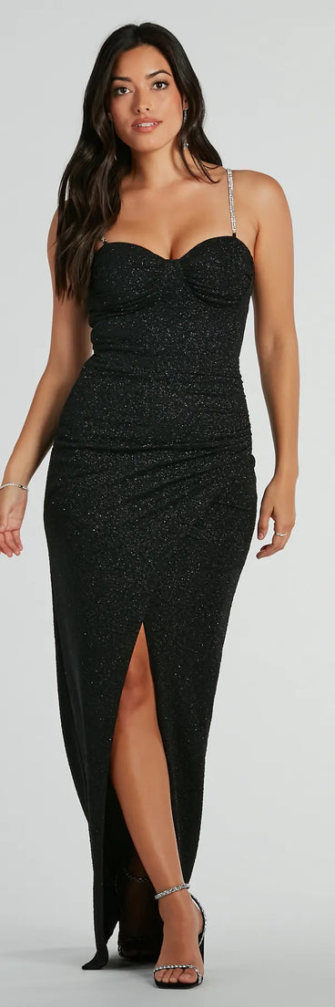 Turn heads at Prom 2025 in this black prom dress, where statement-making details meet the iconic style of the Hilary Rhinestone Strap Slit Glitter Formal Dress .