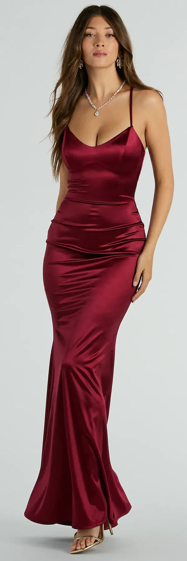 Turn heads at Prom 2025 in this burgundy prom dress, where statement-making details meet the iconic style of the Emmie Lace-Up Mermaid Satin Formal Dress .