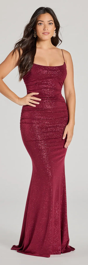 Turn heads at Prom 2025 in this burgundy prom dress, where statement-making details meet the iconic style of the Rowan Formal Glitter Ruched Mermaid Dress .