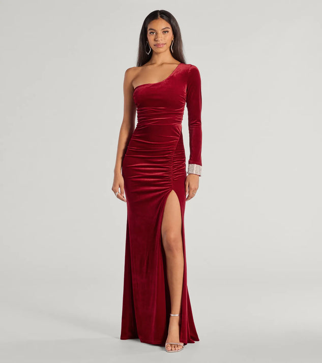 The Lyra Velvet One-Shoulder Rhinestone Cuff Mermaid Dress is a wine dress, an essential holiday or NYE dress that pairs chic style with versatility making it perfect for cocktail events, New Year's Eve parties, or as a winter wedding guest look.