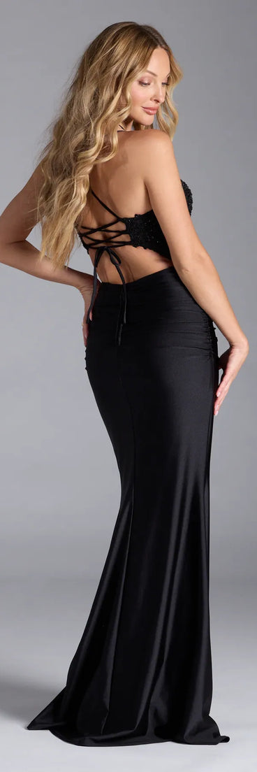 Turn heads at Prom 2025 in this black prom dress, where statement-making details meet the iconic style of the Carena Corset Lace-Up Slit Formal Dress.
