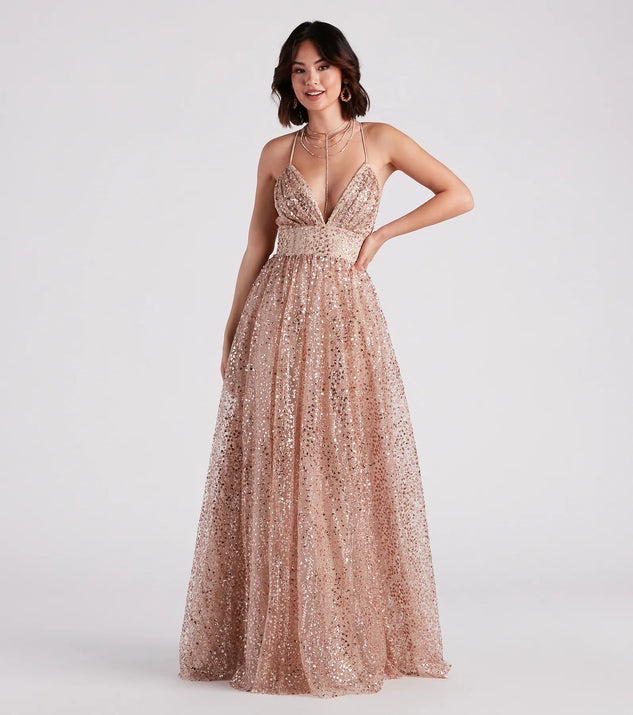 The Stacy Glitter Sequin Tulle Ball Gown is a shimmery gold glitter dress that catches the light beautifully, perfect for any special outfit like Winter Formal attire, clubwear, or a wedding guest dress.