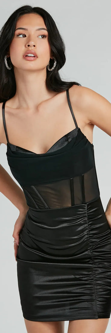 Step into winter chic with the Sexy Chic Ruched Satin And Mesh Corset Mini Dress, a black mini dress featuring an above-the-knee cut ideal for cocktail parties, festive gatherings, or clubwear.