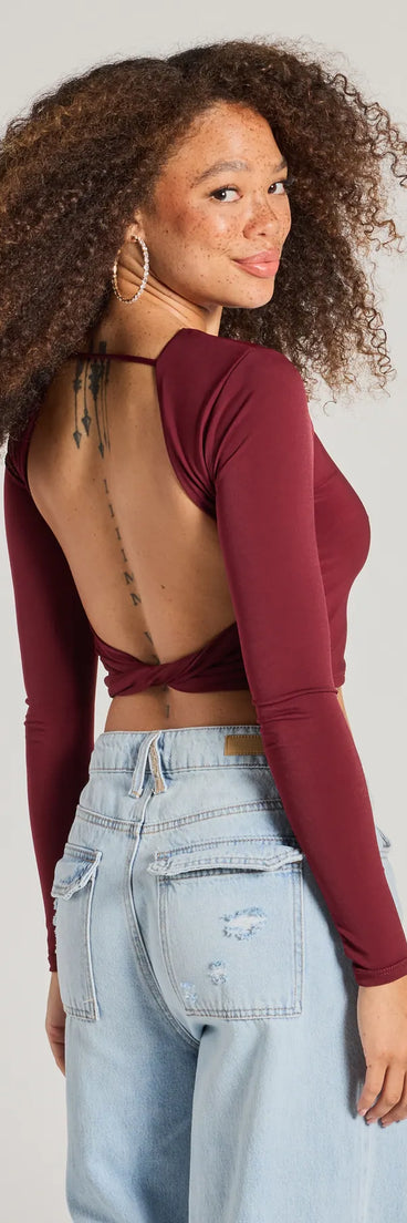The Stop And Stare Backless Long Sleeve Top is a women's burgundy long-sleeve top with an elevated style and unique design accents, perfect for layering or transitioning into colder months.