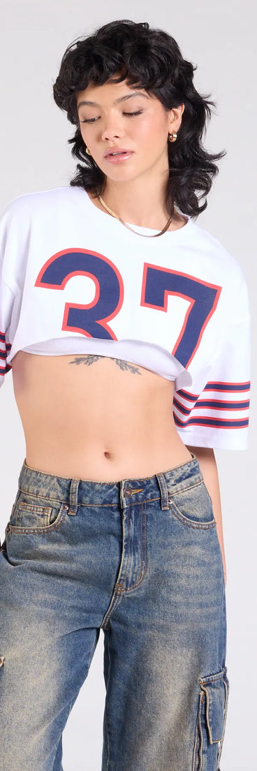 The Go Team Varsity Graphic Crop Tee in white brings edge and energy to your vibe, ready to elevate any festival look or concert outfit.