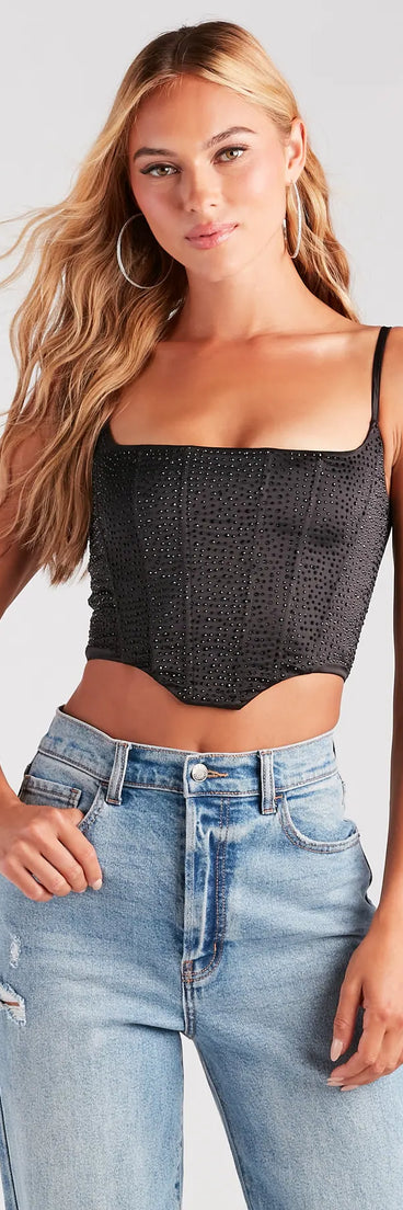 The waist-defining bodice style of the Heat Of The Moment Rhinestone Satin Corset Top in black is perfect for making a statement with your outfit and provides the structure, molded cups, or lace-up details that capture the corset trend.