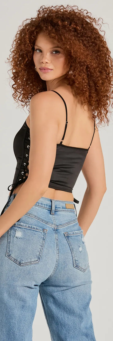 The Love It Lace-Up Satin Cropped Corset Top in black is a sequin top with an all-over sparkle, perfect for creating a glam concert outfit or adding shimmer to a going-out look.