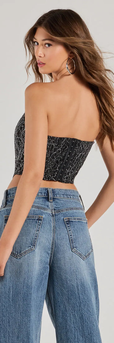 The waist-defining bodice style of the Sultry Shimmer Lurex Lace Strapless Corset Top in black is perfect for making a statement with your outfit and provides the structure, molded cups, or lace-up details that capture the corset trend.