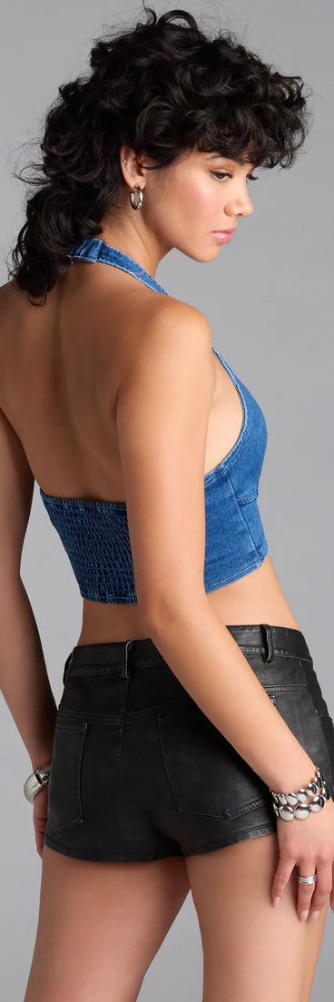 With its midriff cut and trend-forward fit, the Buckled Babe Halter Denim Crop Top is a denim blue crop top made to pair with skirts, denim, or whatever vibe you're feeling this season.