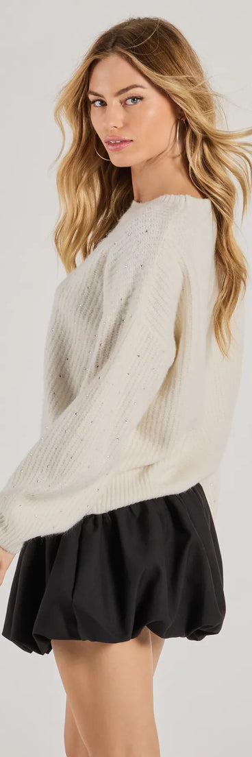 Layer-friendly Cozy Sparkle Rhinestone Ribbed Knit Sweater is a chic, transitional ivory long-sleeve top with contemporary sleeves and neckline design, ideal for an elevated cozy style or casual elegance.