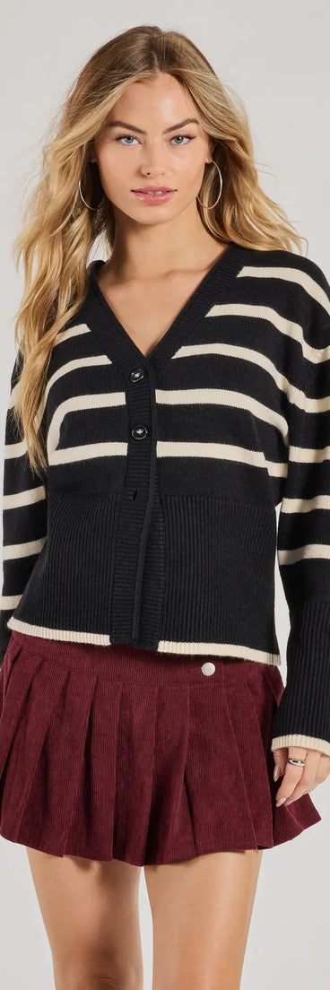 The Classic And Cozy Striped Knit Oversized Cardigan in black with a modern design and trendy look is part of the latest women's tops collection to elevate your 2025 wardrobe.