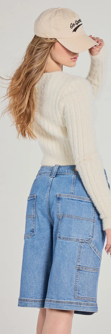With its midriff cut and trend-forward fit, the Adorably Cozy Eyelash Knit Button-Down Cardigan is a ivory crop top made to pair with skirts, denim, or whatever vibe you're feeling this season.