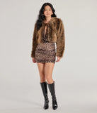 The Untamed Luxe Cropped Faux Fur Jacket in brown is a women's workwear piece offering a trendy style and unique accents, perfect for effortlessly creating an outfit-of-the-day look that transitions your office look to going-out ready.