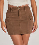 The Serving Style Cargo Mini Skirt is a brown cargo skirt, an effortlessly layer-friendly piece ideal for a holiday-ready look with a funtional-inspired flair.