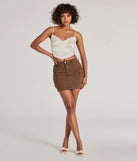 The Serving Style Cargo Mini Skirt is a brown cargo skirt, an effortlessly layer-friendly piece ideal for a holiday-ready look with a funtional-inspired flair.