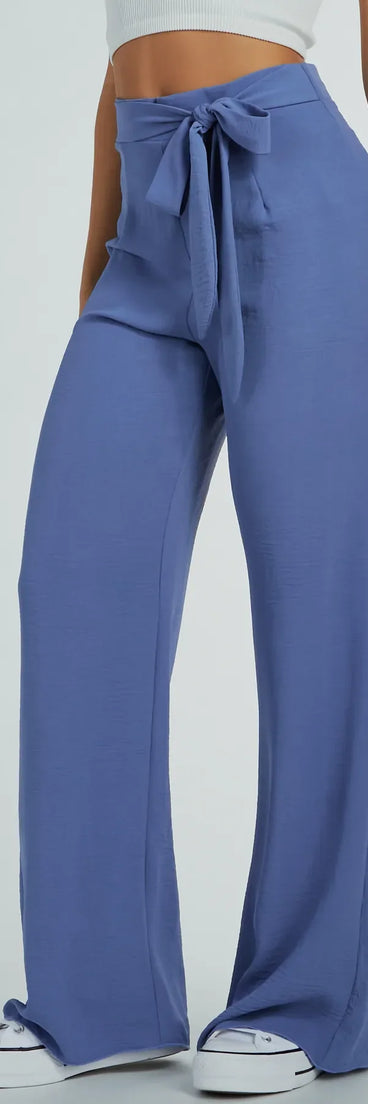 The Sittin Pretty Tie Waist Wide-Leg Palazzo Pants in denim is a women's workwear piece offering a trendy style and unique accents, perfect for effortlessly creating an outfit-of-the-day look that transitions your office look to going-out ready.