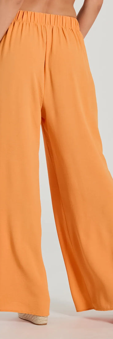 The Flirty Match High-Rise Palazzo Pants in orange is a versatile pair of women's pants with trendy design accents, crafted for holiday-ready looks, from office wear to sophisticated winter night outs.