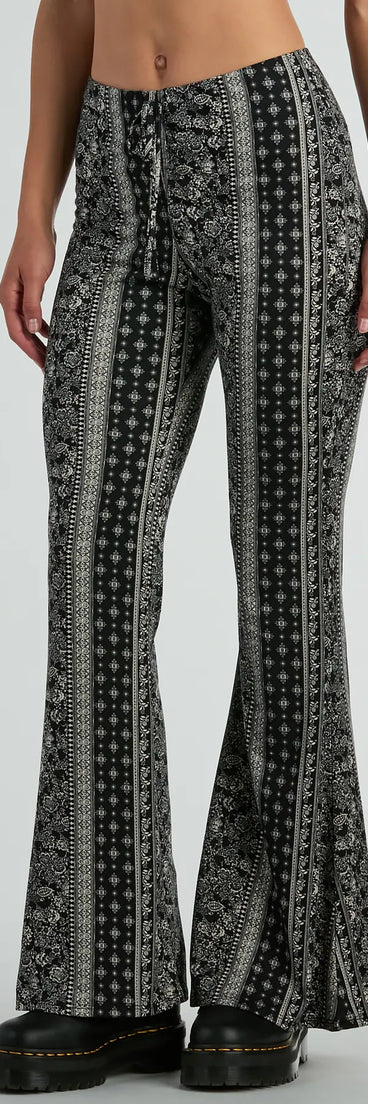 The To The Sky Boho V-Waist Tie Flare Pants in black is a versatile pair of women's pants with trendy design accents, crafted for celebration-ready looks, from office wear to sophisticated winter night outs.