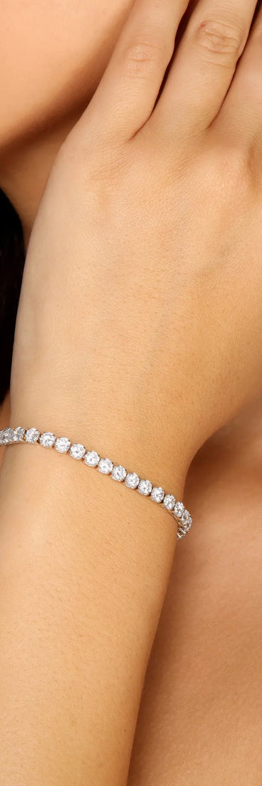 Get ready for any event with the Cubic Zirconia Tennis Bracelet in silver, an essential start to creating a versatile holiday outfit for women for holiday parties, cocktail hours, or NYE events.