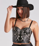 The waist-defining bodice style of the Radiant Glamour Rhinestone Faux Leather Corset is perfect for making a statement with your outfit and provides the boning, molded cups, or lace-up details that capture the corset trend.