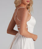 The Sonya Satin Dress is a mini dress in ivory, perfect for an above-the-knee holiday party dress or a stylish NYE look, with a short hemline designed to make a winter statement.
