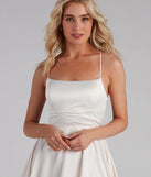 The Sonya Satin Dress is a stunning ivory mini dress with a short hem, designed to be the perfect winter cocktail dress or night-out look for the holiday season.