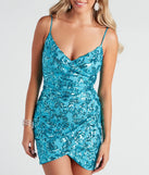 Make a bold statement in the Maeve Sequin Wrap Mini Dress in turquoise, the perfect green dress for weddings, cocktail hours, nights out, and/or seasonal celebrations.