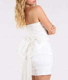 Make a bold statement in the Lucy Taffeta Bow Mini Party Dress in white, the perfect spring dress for weddings, cocktail hours, nights out, and/or seasonal celebrations.