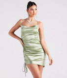 Step into winter chic with the Kristy Satin Cowl Neck Party Dress, a sage mini dress featuring an above-the-knee cut ideal for cocktail parties, festive gatherings, or clubwear.
