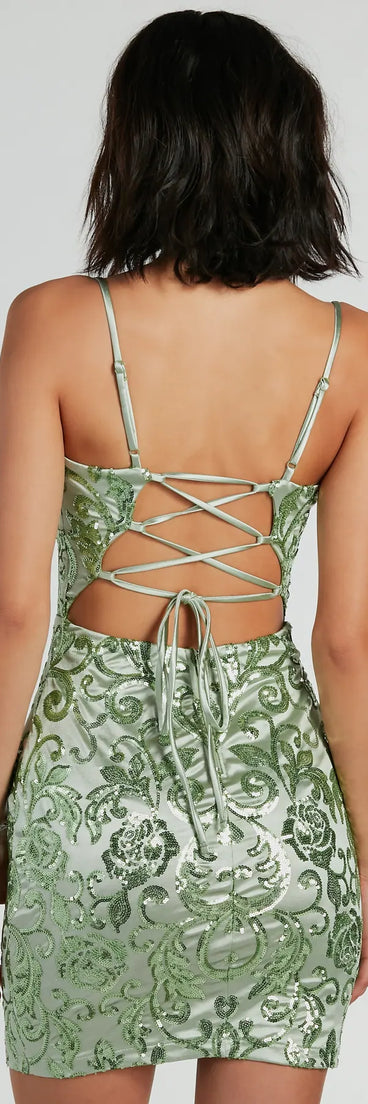 The Laurita Lace-Up Sequin Satin Party Dress is a mini dress in sage, perfect for an above-the-knee holiday party dress or a stylish NYE look, with a short hemline designed to make a winter statement.