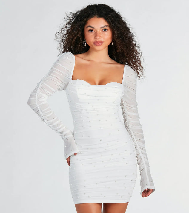 Step into seasonal chic with the Tracey Mesh Faux Pearl Bodycon Party Dress, a white mini dress featuring an above-the-knee cut ideal for cocktail parties, festive gatherings, or clubwear.
