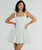 Step into seasonal chic with the Brenda Low Back Bow Taffeta Skater Dress, a white mini dress featuring an above-the-knee cut ideal for cocktail parties, festive gatherings, or clubwear.