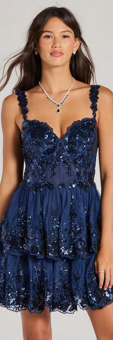 Step into winter chic with the Michelle Corset Sequin Applique Ruffle Skater Dress, a navy mini dress featuring an above-the-knee cut ideal for cocktail parties, festive gatherings, or clubwear.