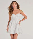 Turn heads in the beaming Chloe Sequin Embroidered Mesh Skater Dress, a stunning white sequin dress designed to add sparkle and elegance to your next night out or special occasion.