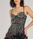 Revamp your 2025 wardrobe with this chic addition, the Rosalie Rhinestone Faux Pearl Ruffle Mini Dress in black, perfect for elevating your style in the new year.