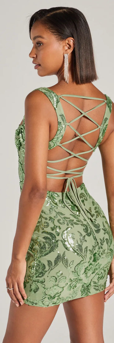 The Aubree Lace-Up Sequin Party Dress in sage is a stunning green prom dress designed to capture attention with its fresh or bold color and effortlessly stylish silhouette.