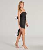 Make a bold statement in the Reese Woven Glitter Knit Open-Back Bow Mini Dress in black, the perfect spring dress for weddings, cocktail hours, nights out, and/or seasonal celebrations.