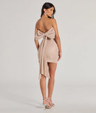 Own every entrance in the Reese Woven Glitter Knit Open-Back Bow Mini Dress, a pink party dress perfect for milestone birthdays and grad parties, or dancing through summer nights and unforgettable bachelorette celebrations.