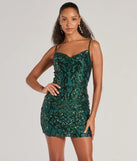 Turn heads in the beaming Amara Sleeveless Sequin Cowl Neck Mini Dress, a stunning hunter sequin dress designed to add sparkle and elegance to your next night out or special occasion.