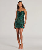 The Amara Sleeveless Sequin Cowl Neck Mini Dress is a dazzling hunter sequin dress, perfect for making a bold entrance at any event, from cocktail parties to formal celebrations.