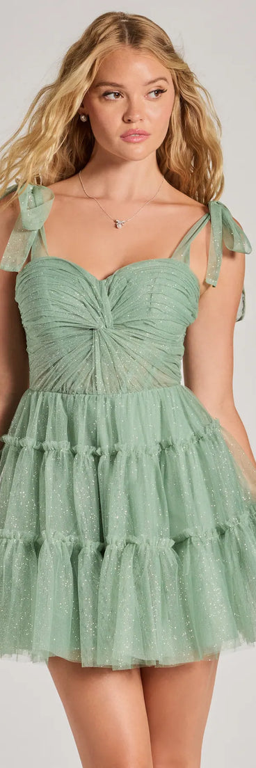 Own every entrance in the Lizzy Ruffled Glitter Mesh Skater Dress, a sage green party dress perfect for milestone birthdays, homecoming dances, and unforgettable bachelorette celebrations.