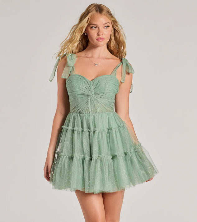 Turn heads at Prom 2025 in this sage green prom dress, where statement-making details meet the iconic style of the Lizzy Ruffled Glitter Mesh Skater Dress .
