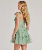 The Lizzy Ruffled Glitter Mesh Skater Dress in sage is a stunning green prom dress designed to capture attention with its fresh or bold color and effortlessly stylish silhouette.