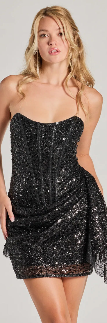 Turn heads in the beaming Candance Strapless Corset Sash Sequin Mini Dress, a stunning black sequin dress designed to add sparkle and elegance to your next night out or special occasion.