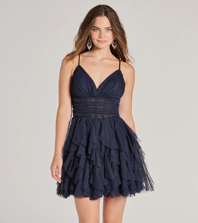Step into seasonal chic with the Leanna Ruffle Glitter Mesh Skater Dress, a navy mini dress featuring an above-the-knee cut ideal for cocktail parties, festive gatherings, or clubwear.