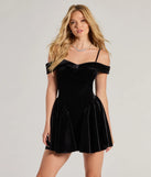 Andie Velvet Drop Waist Skater Dress, a trendy black mini dress featuring modern details and a fresh seasonal hue, perfect for creating chic 2025 looks.