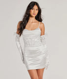 Step into seasonal chic with the Anastasia Corset Tulle Bow Satin Mini Dress With Gloves, a white mini dress featuring an above-the-knee cut ideal for cocktail parties, festive gatherings, or clubwear.