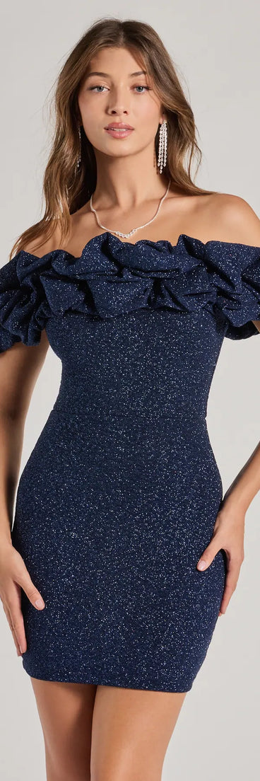 Step into seasonal chic with the Ember Off-The-Shoulder Ruffle Glitter Party Dress, a navy mini dress featuring an above-the-knee cut ideal for cocktail parties, festive gatherings, or clubwear.